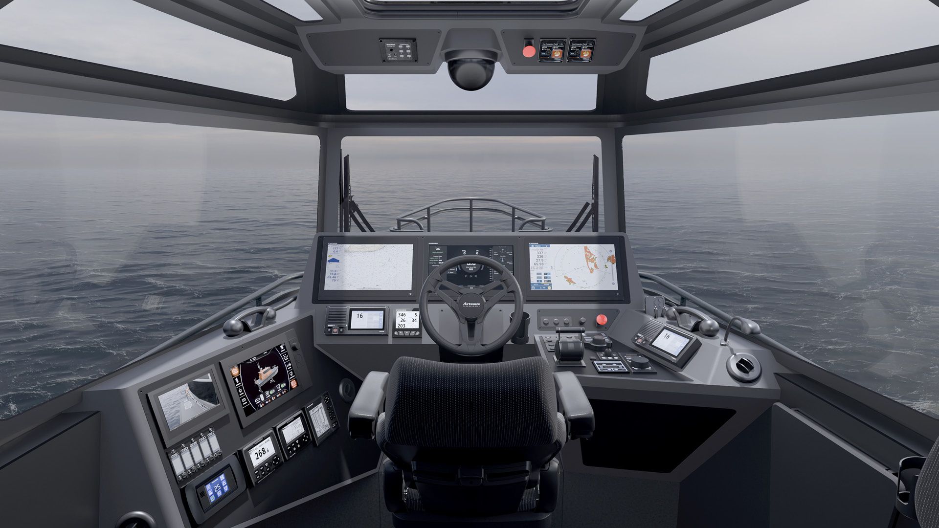 An image showing the console layout at the helm of the Artemis EF-12 Pilot electric hydrofoiling vessel. Showing the human machine interface (HMI) screens, wheel and other controls. 