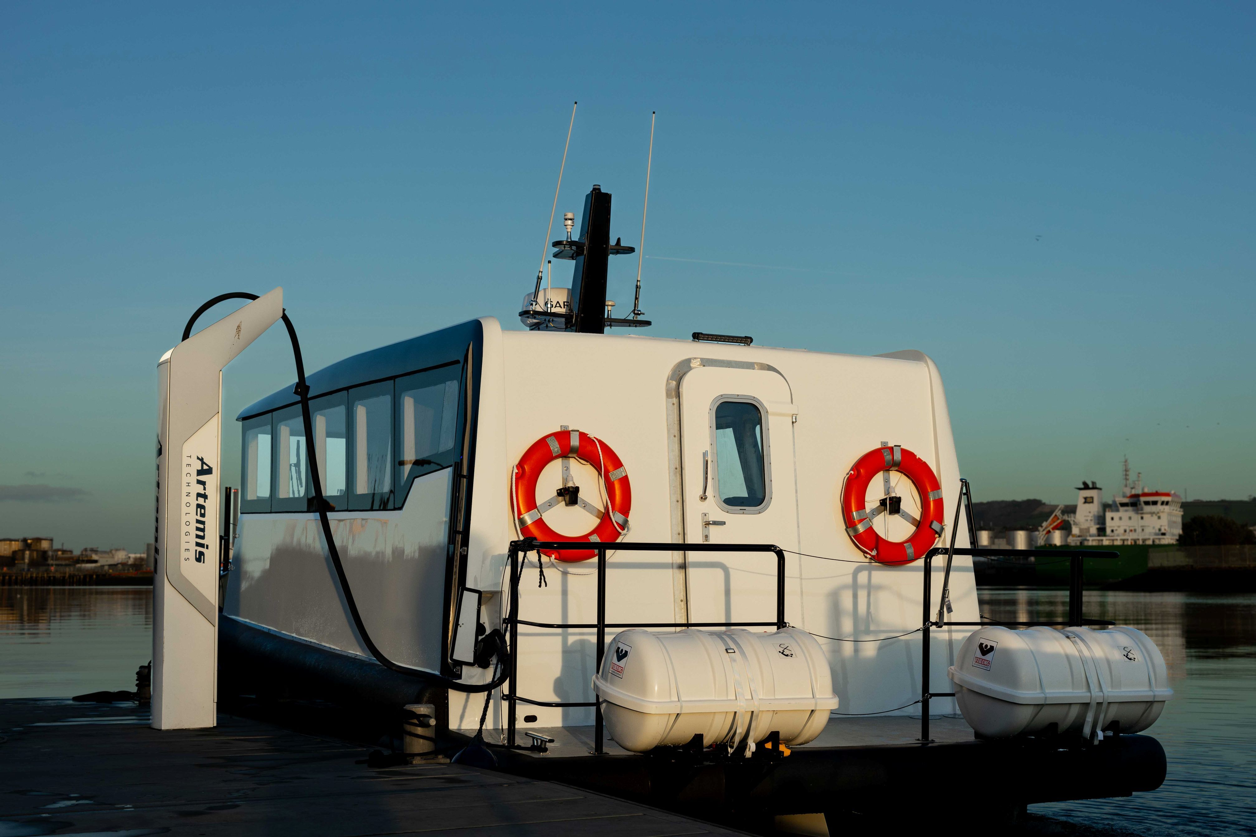White and navy Artemis EF-12 Workboat XL with shoreside charger plugged in