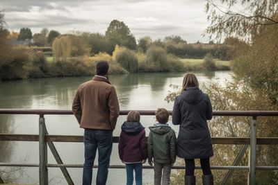 Family On Bridge Over River