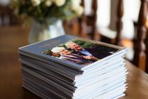 Stack Of Order Of Service Booklets On Table