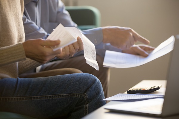 Hands Holding Documents To Review