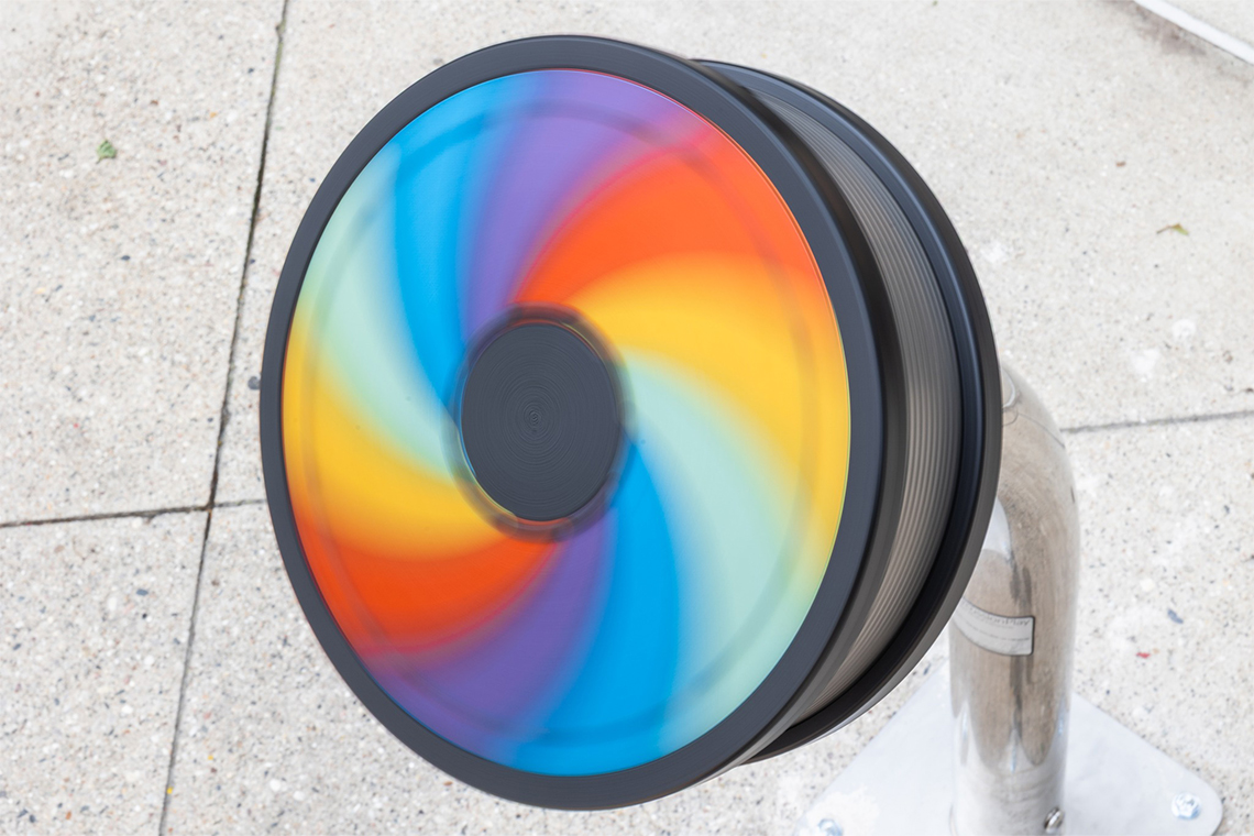 A rainbow colored rainwheel in full spin
