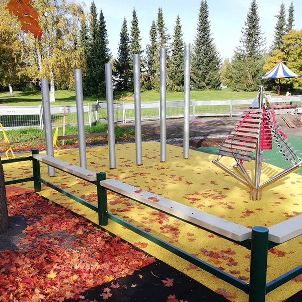 Large tall silver chimes and an outdoor xylophone in a musical playground in Finland