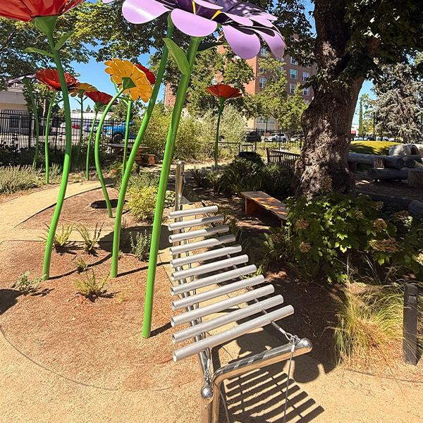 a silver outdoor xylophone in a childrens museums outdoor music garden