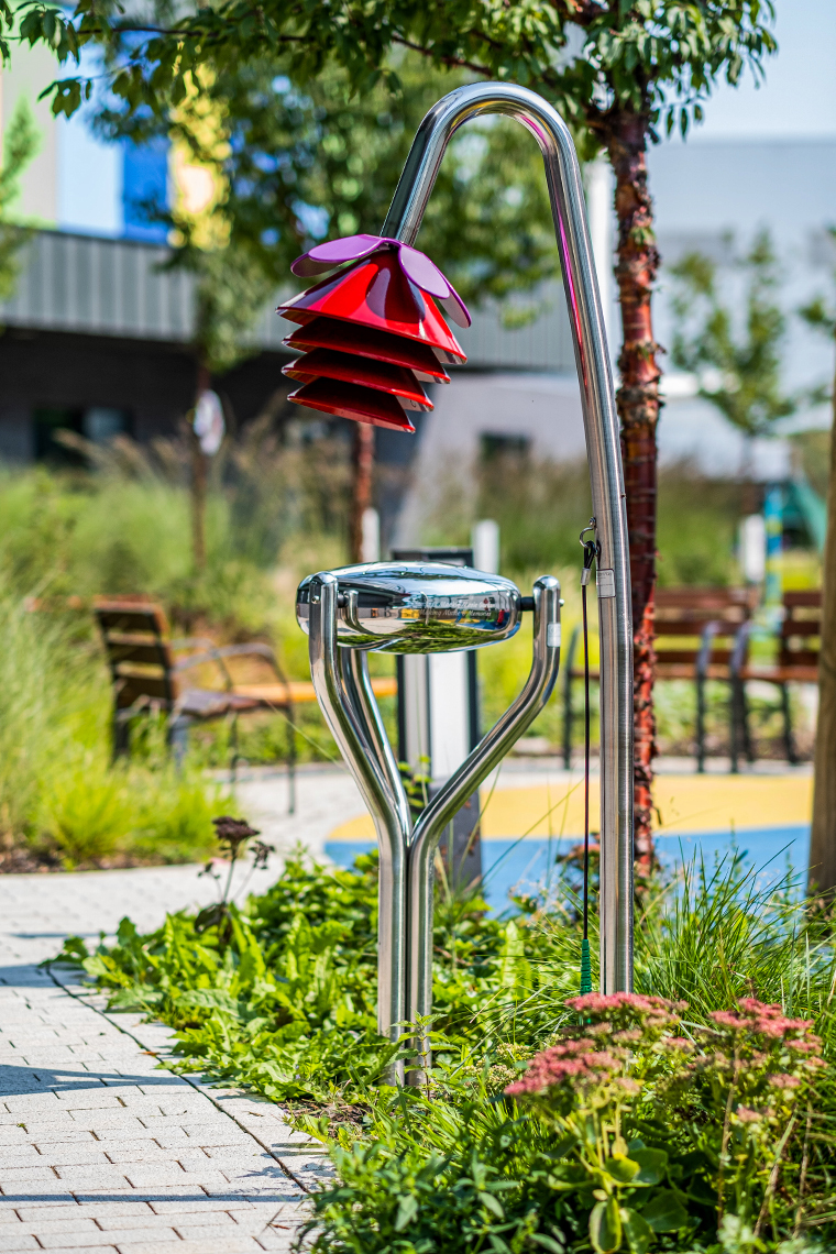 an outdoor drum and also outdoor bell shaped like a flower in a musical memorial garden