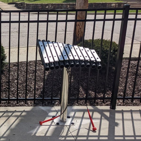 a small outdoor xylophone with black resonators and aluminum notes outside the Scenic Regional Library St Clair Branch