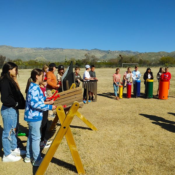 pupils from Tanque Verde School playing large outdoor musical instruments in their new outdoor music classroom