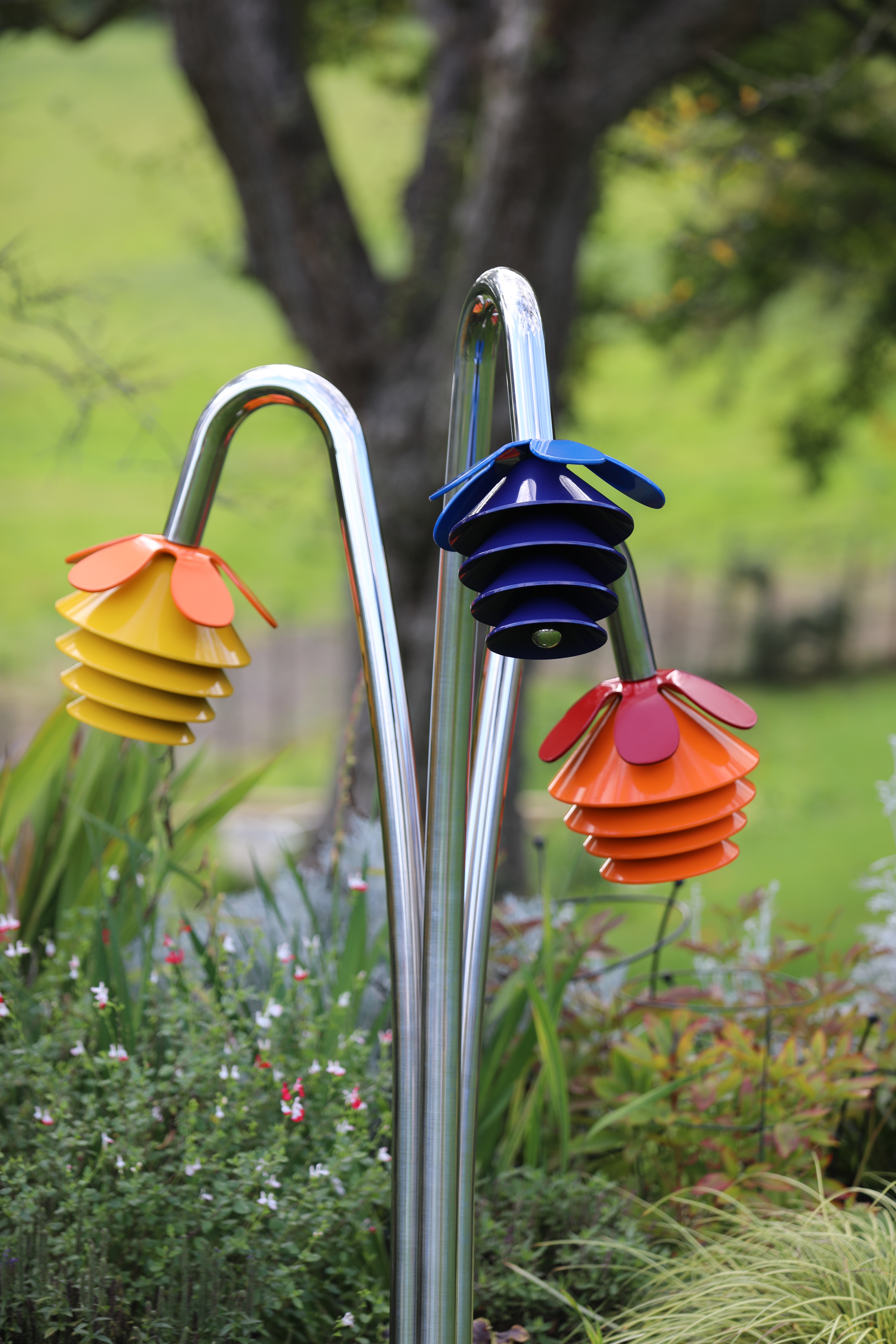  a 'bunch' of three metal outdoor musical flowers grouped together on a stainless steel 'stem' for playgrounds or sensory gardens