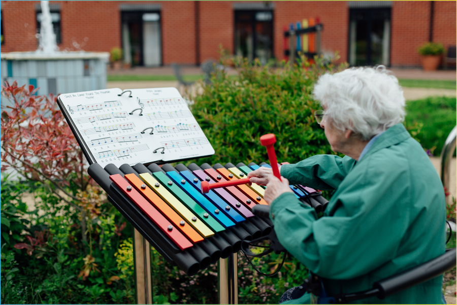 senior lady in a care home courtyard garden designed for seniors