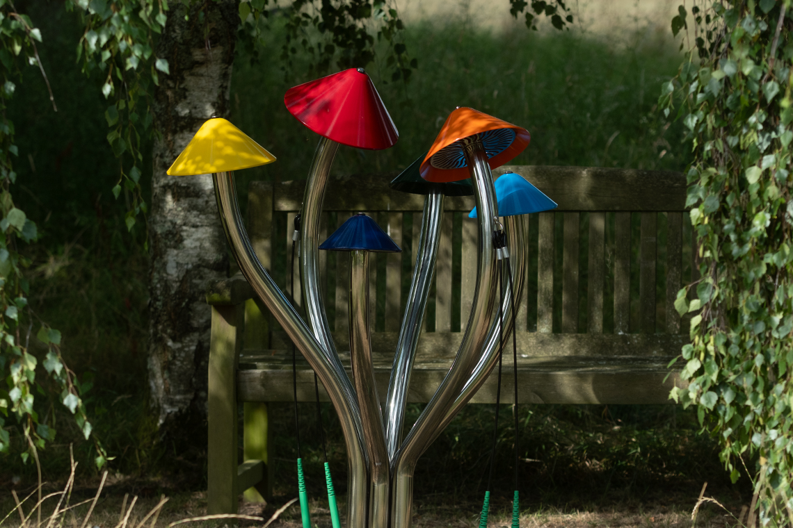 a large colorful outdoor musical instrument that resembles a clump of field mushrooms